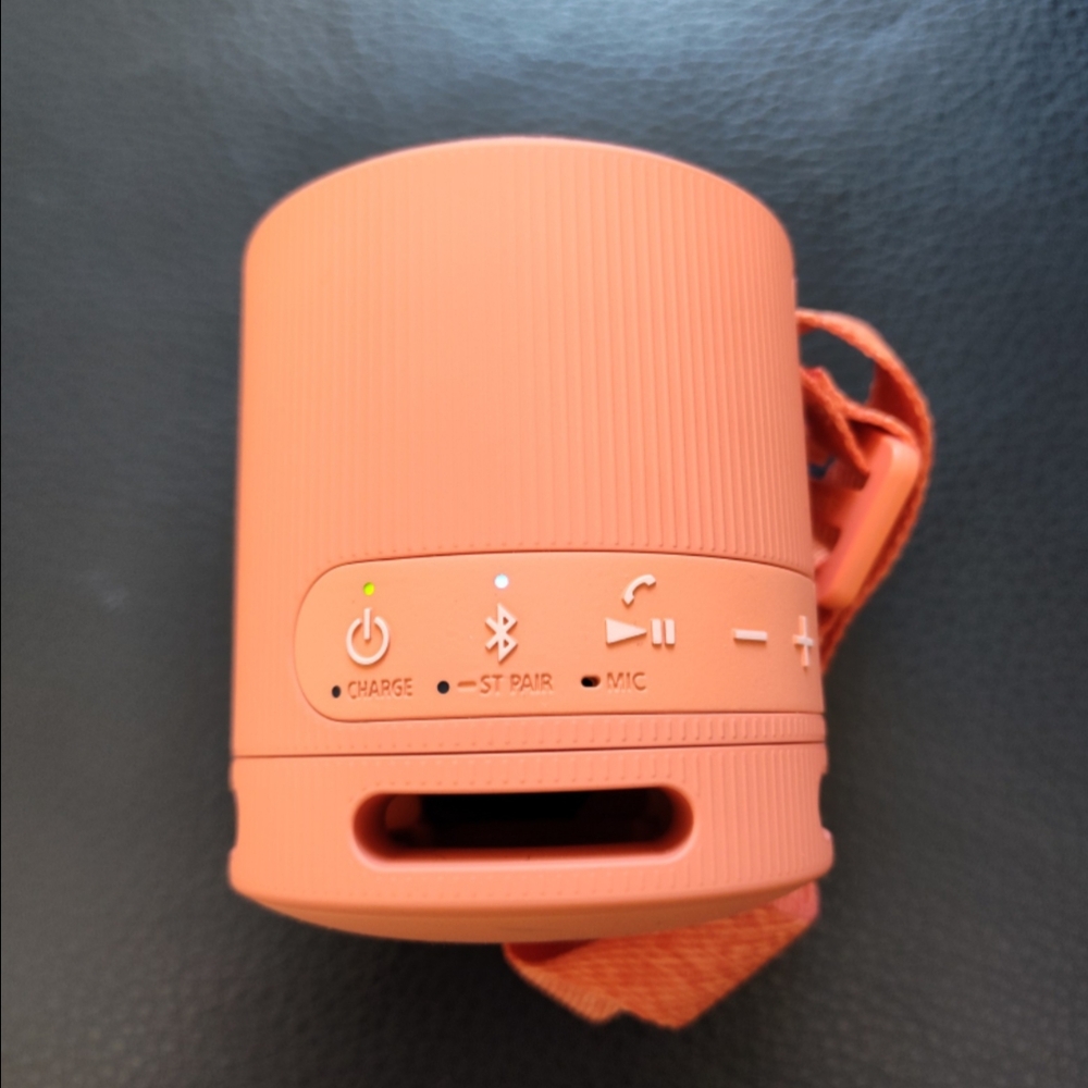 Orange Portable Speaker with Textured Design and Carrying Strap